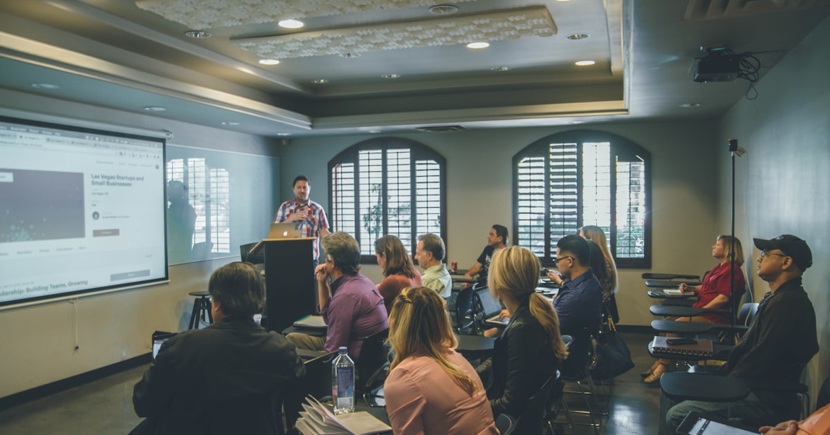 Teacher presenting to a group of students in a classroom setting